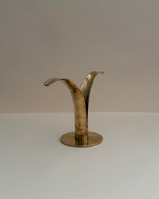 Overhead view of the two curved brass wings and central candle opening of the Ystad Metall Liljan candlestick.