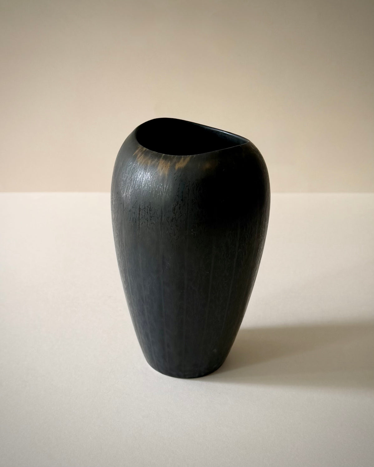 Angled view of the Rörstrand AXZ vase highlighting the rim and textured glaze.