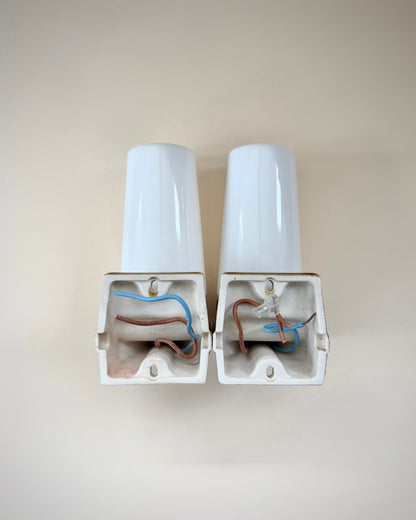 Exposed original wiring inside the ceramic bases of the Ifö Bernadotte wall lamps.