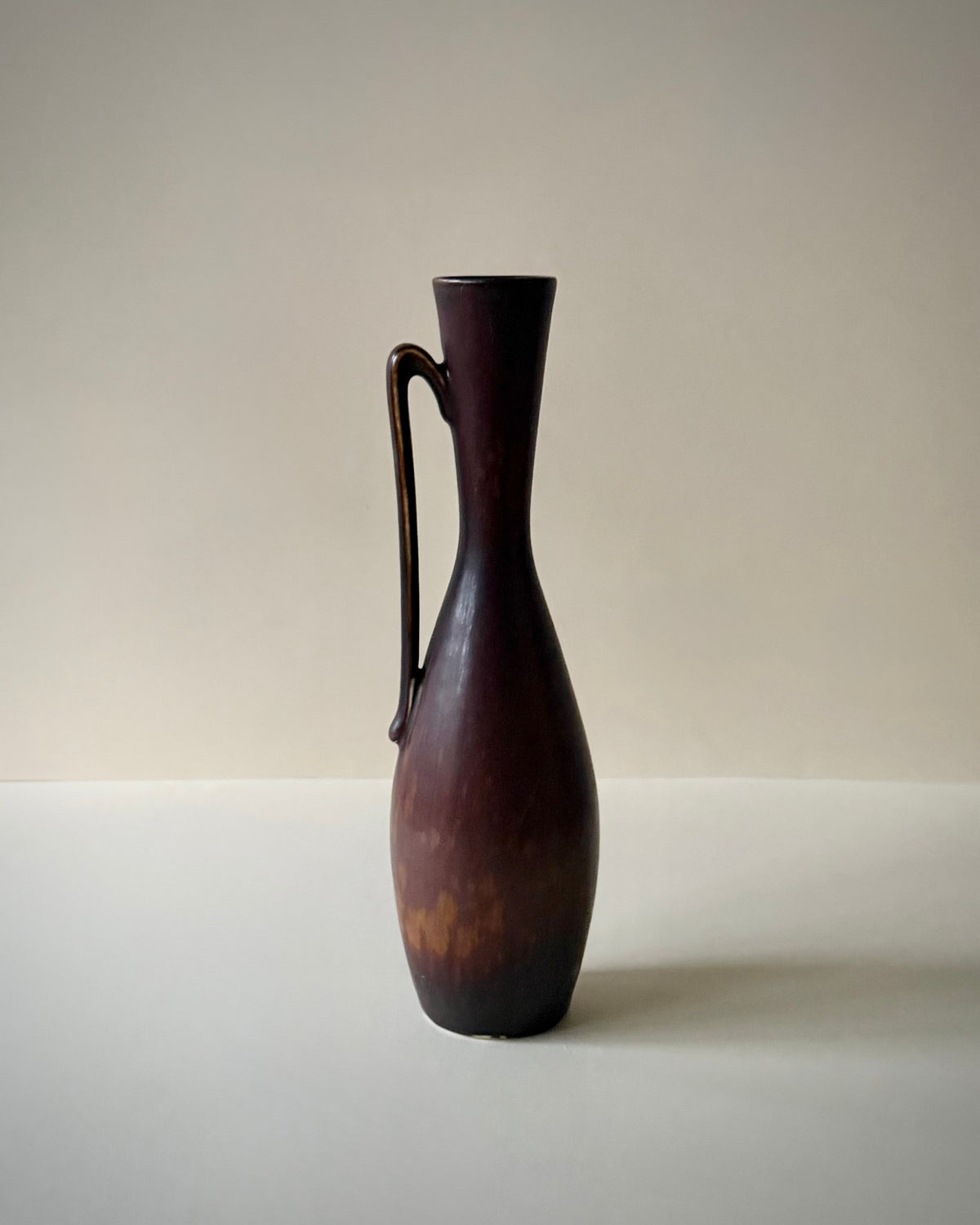 Full view of the Rörstrand NSZ vase showing its deep reddish-brown glaze and original paper label.