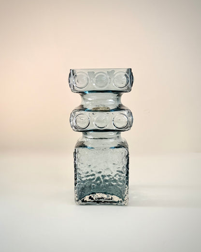 Riihimäen Lasi Kehrä 1496 steel blue glass vase, front view showing its textured square body and circular reliefs.