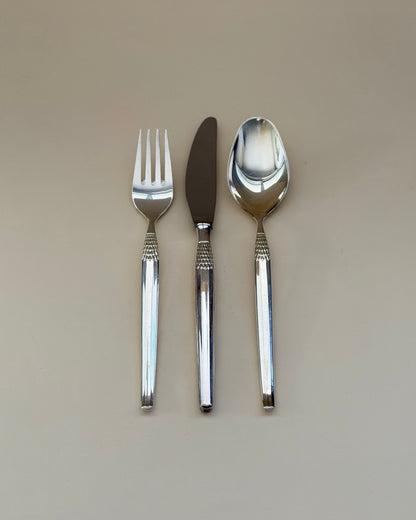 Eight GAB Cheri silver-plated table knives arranged in a row, showing their textured handles.