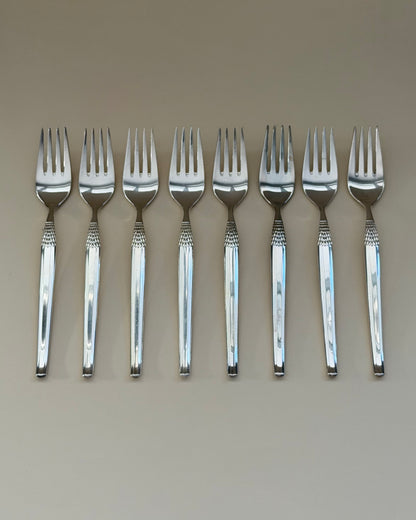 A GAB Cheri table fork, knife and spoon showing the polished surfaces and textured handle detail.