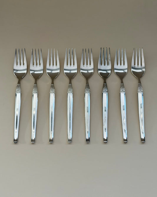 A GAB Cheri table fork, knife and spoon showing the polished surfaces and textured handle detail.