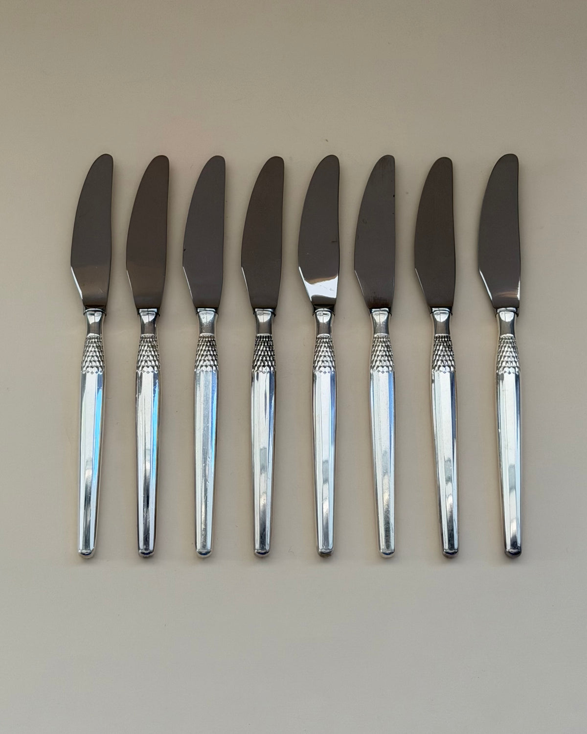 Eight GAB Cheri silver-plated table spoons arranged side by side.