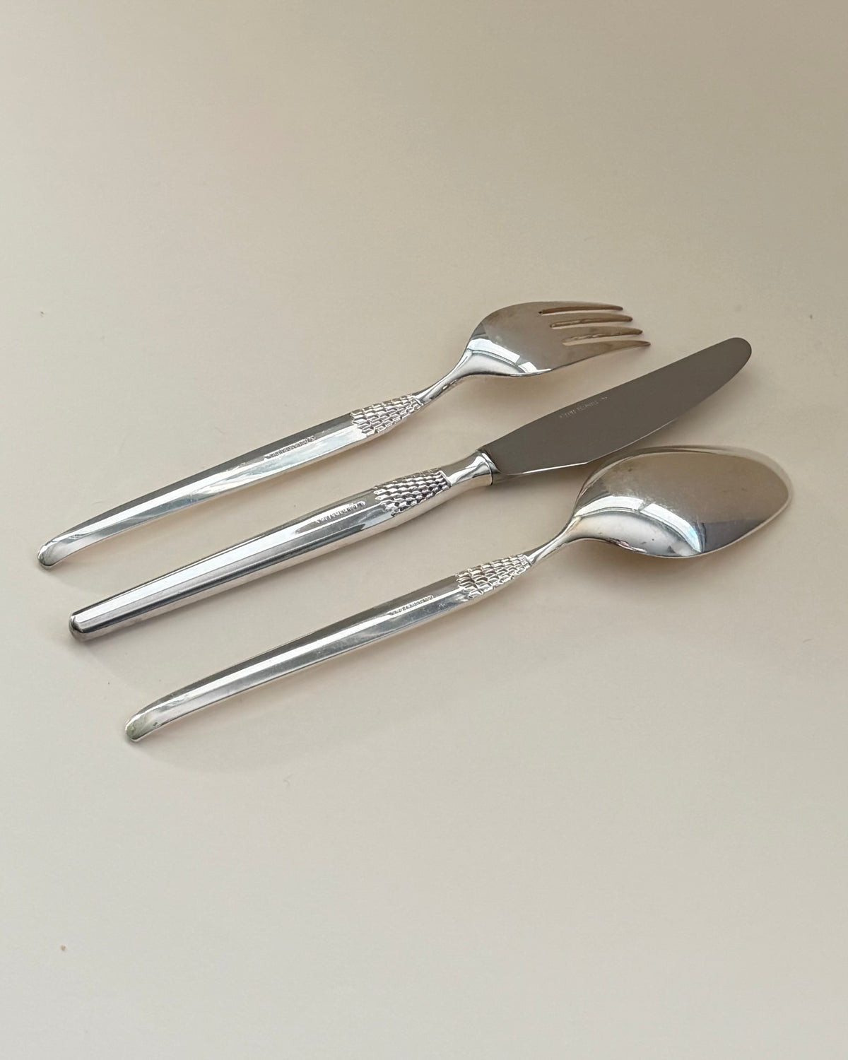 GAB Cheri table fork, knife and spoon shown together at an angle.