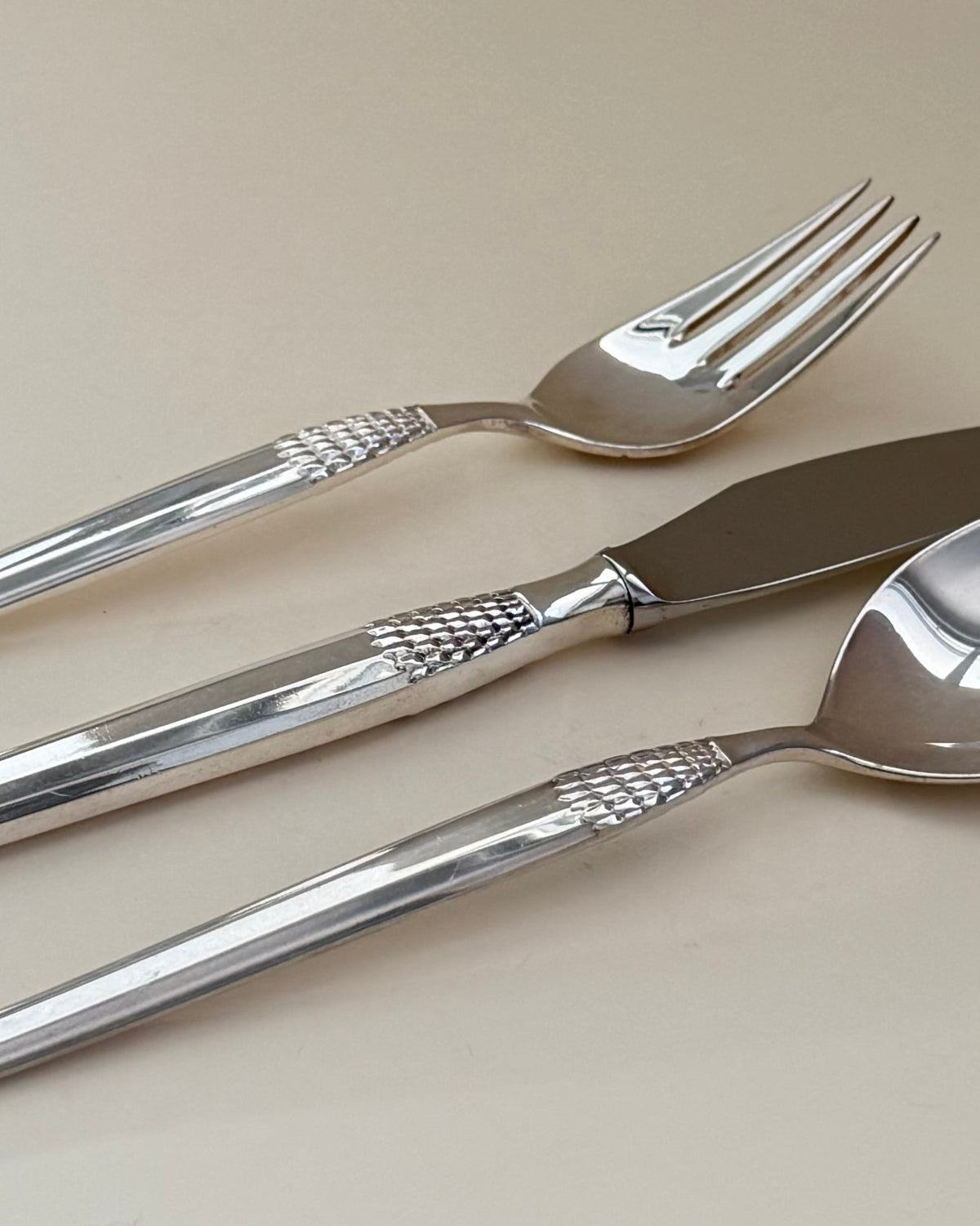 Eight GAB Cheri silver-plated table forks arranged in a row.