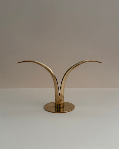 Ystad Metall Liljan solid brass candlestick, front view with two curved lily-like wings and circular base.