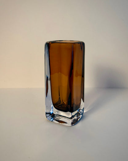 Kosta V. Lindstrand 41903 Sommerso-style glass vase lying on its side, showing the reddish-brown core and clear glass casing