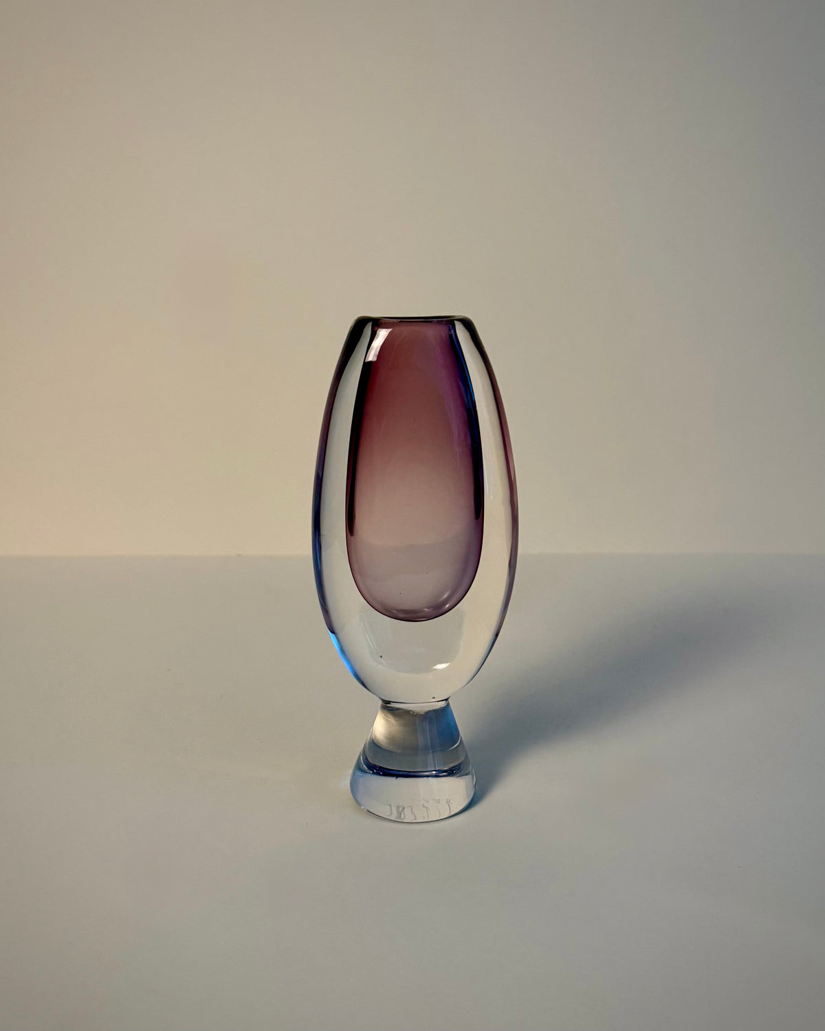Kosta LH 1657/128 Sommerso glass vase by Vicke Lindstrand lying on its side, showing the rim opening and amethyst-purple body