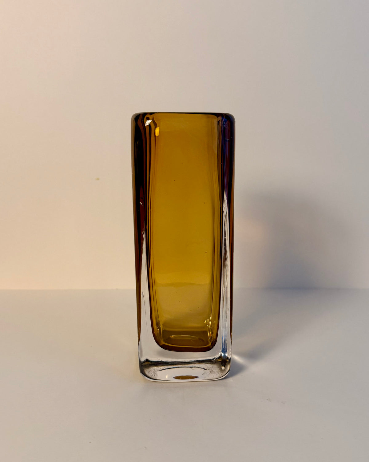 Kosta LH 1898/227 Sommerso glass vase by Vicke Lindstrand lying on its side, showing the amber core and clear glass casing